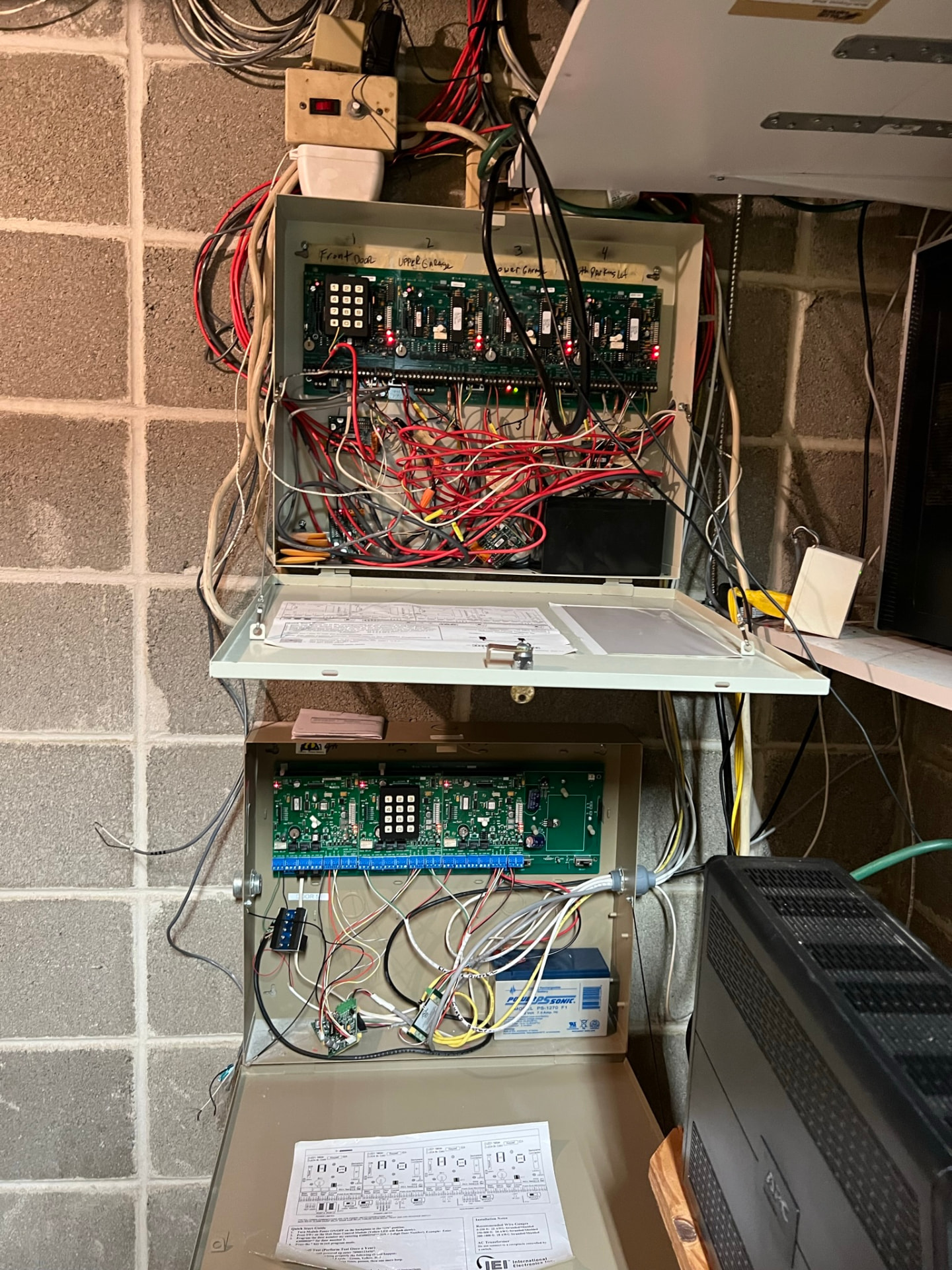 Two open legacy access control panels documented during field troubleshooting by Armor Security Solutions